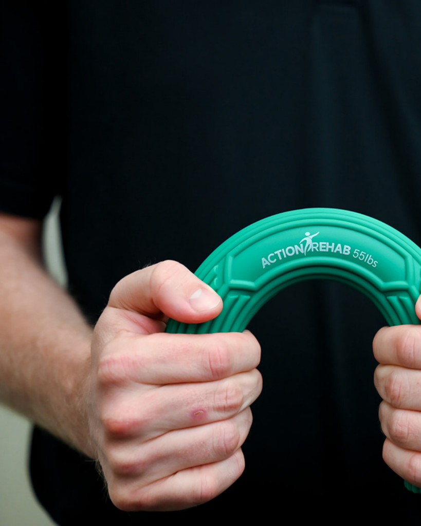 Person performing a hand strengthening exercise using a resistance device during post-operative hand therapy rehabilitation.